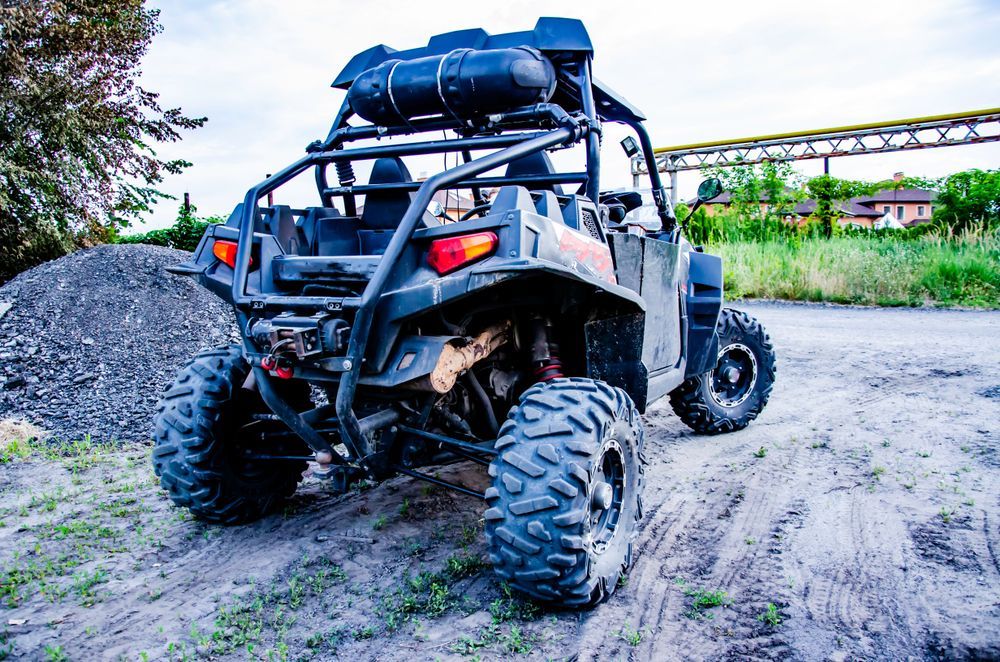 Off-road Vehicle on Dirt With a Pile of Rocks — Atherton Mechanical Services in Atherton, QLD