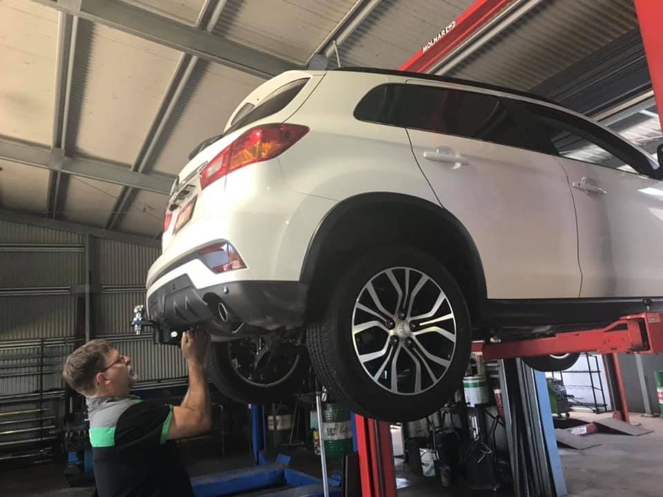 Mechanic Changing Tire on a Vehicle in a Garage — Atherton Mechanical Services in Atherton, QLD