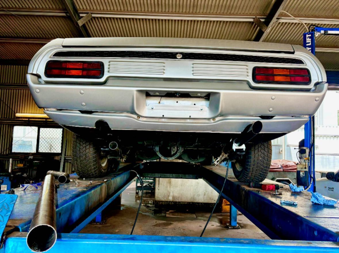 Silver Classic Car on a Lift, Viewed From Below, in a Garage — Atherton Mechanical Services in Mareeba, QLD