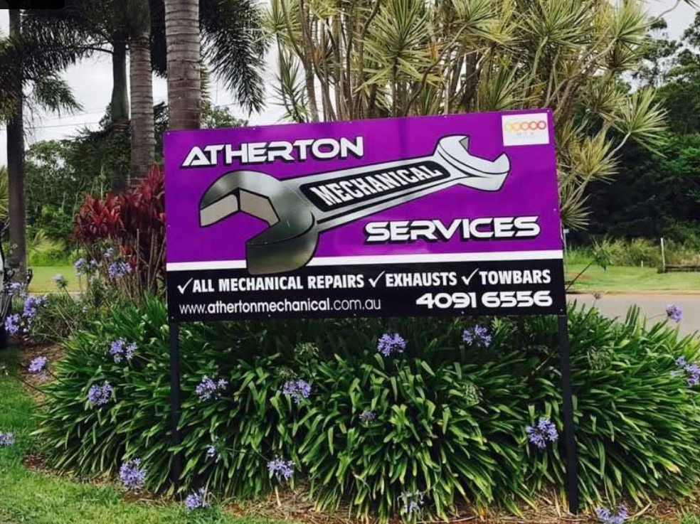 Sign For Atherton Mechanical Services; Purple, White, And Gray, With A Wrench Graphic, In Front Of Bushes — Atherton Mechanical Services in Atherton, QLD