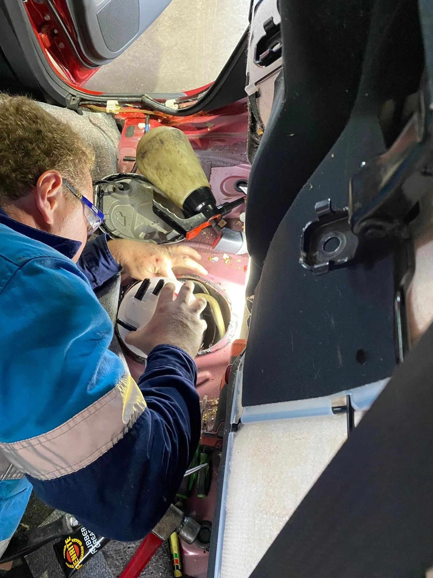 Person in Blue Jacket Working on Car's Fuel — Atherton Mechanical Services in Atherton, QLD