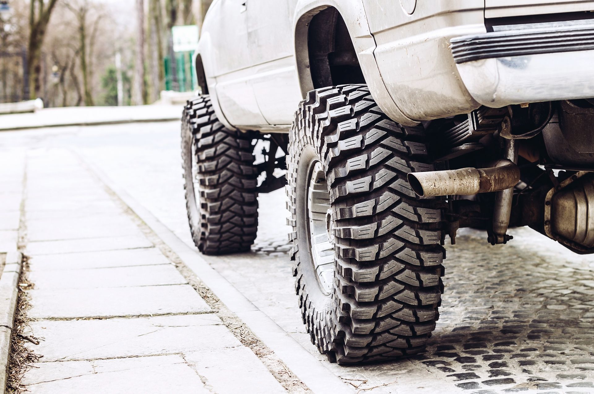 Lifted Truck With Large, Patterned Tires on Cobblestones — Atherton Mechanical Services in Atherton, QLD