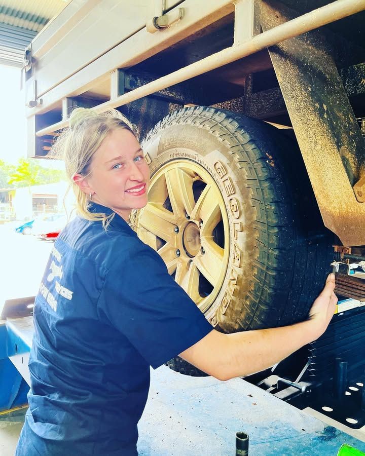 Woman in Blue Shirt Changing a Large Tire — Atherton Mechanical Services in Atherton, QLD