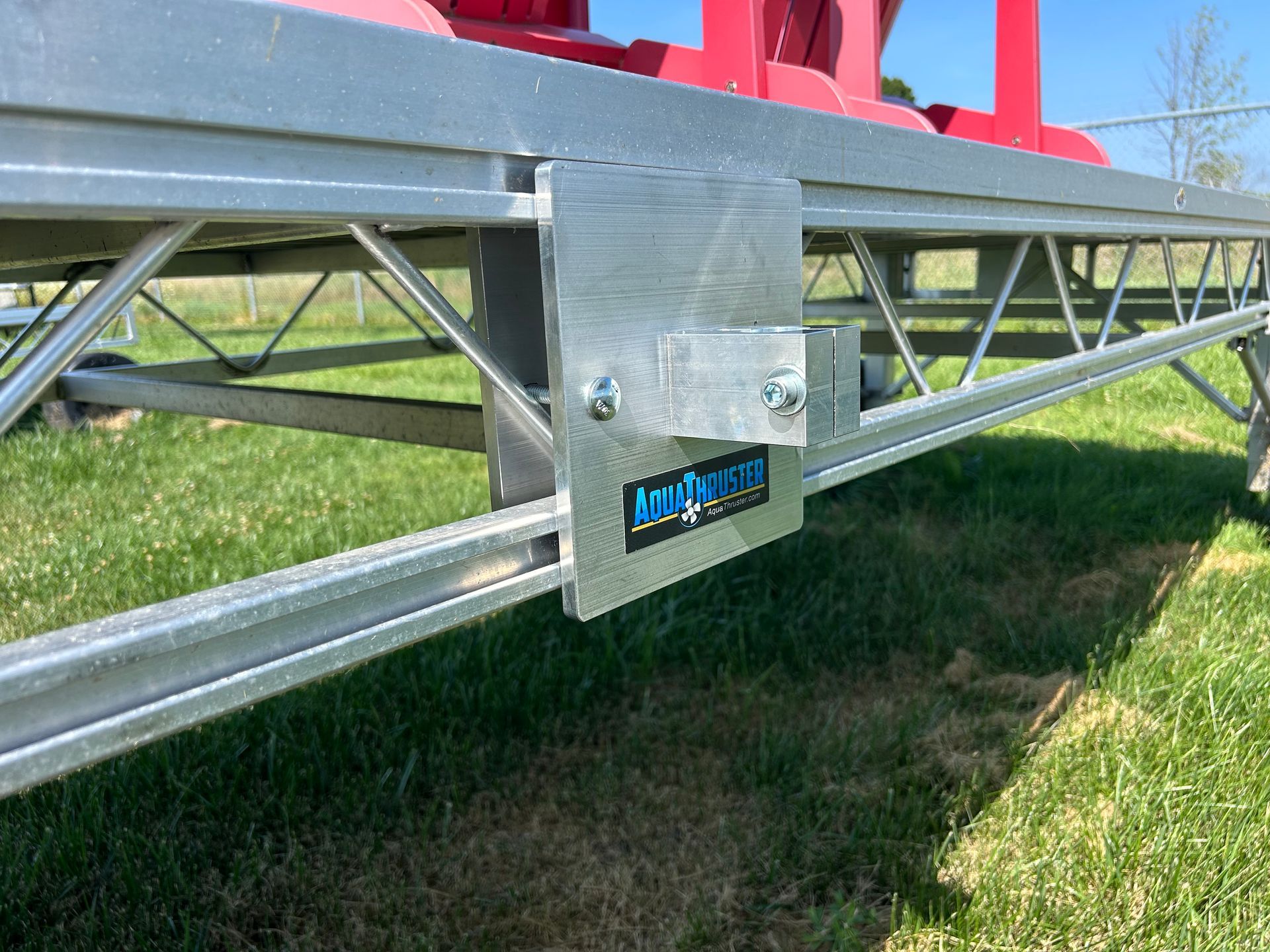 Close-up of a silver metal bracket attached to a dock frame, with