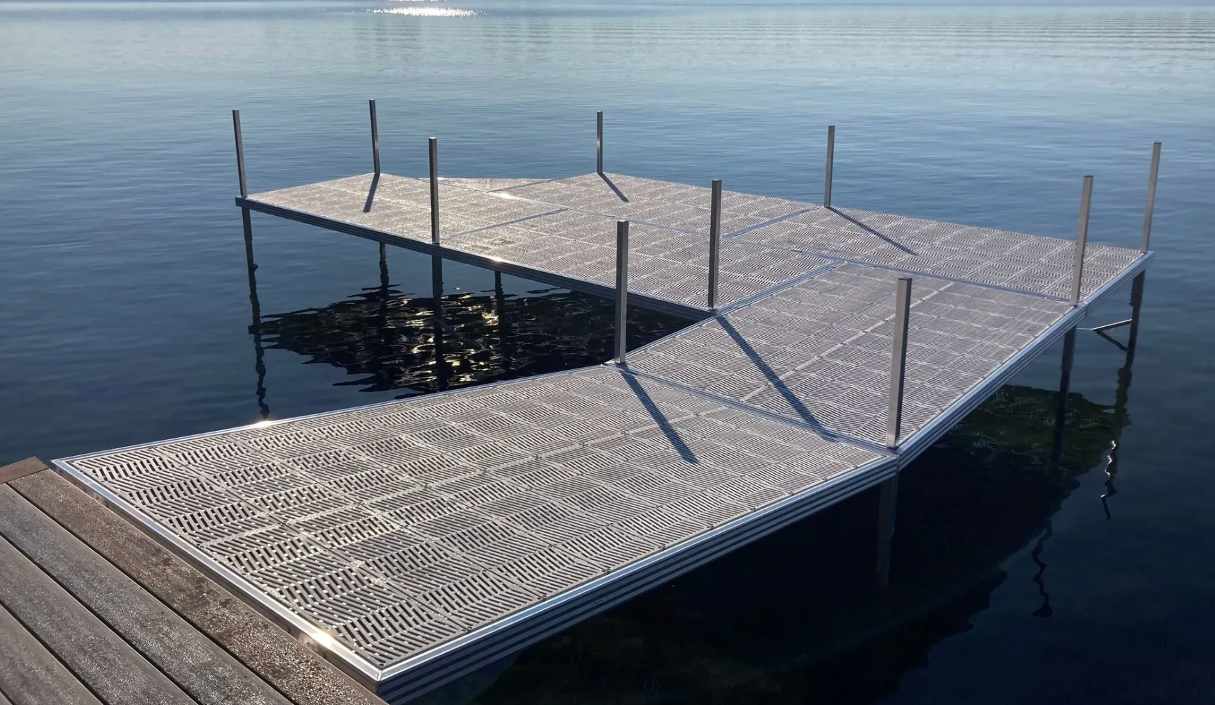 Aluminum dock system extending over calm lake water, year-round waterfront use.