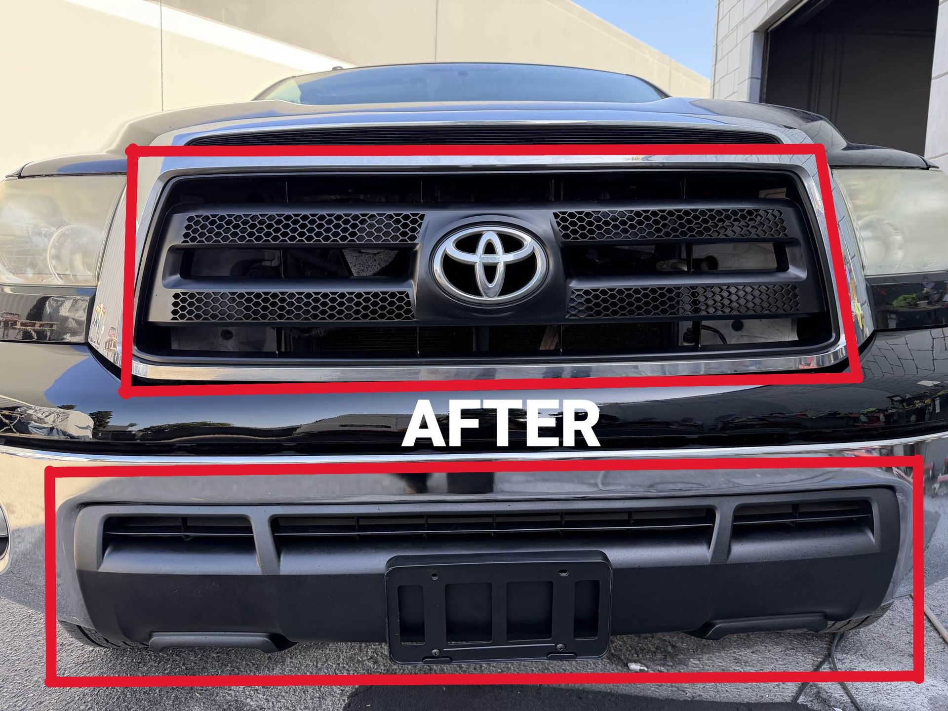 Black Toyota Tundra truck front view, showing grille with Toyota logo and license plate holder.