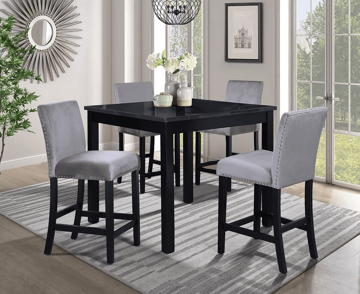 Black square dining table with four gray upholstered bar stools on a patterned rug.