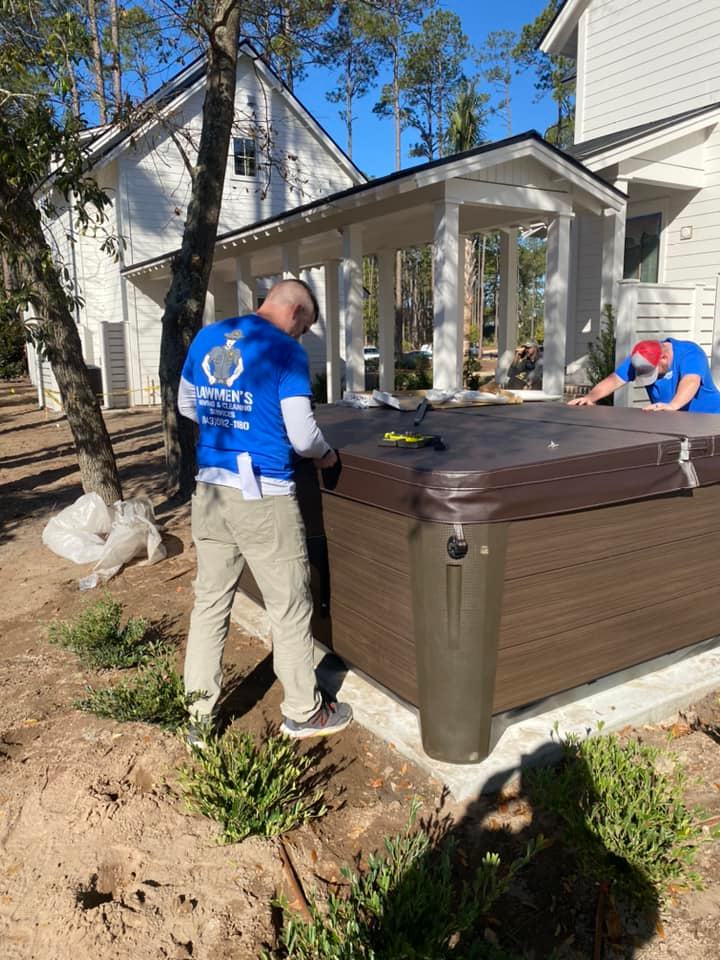 Two Men Installing a Outdoor Bathtub — Blufton, SC — Lawmen's Moving and Cleaning Service