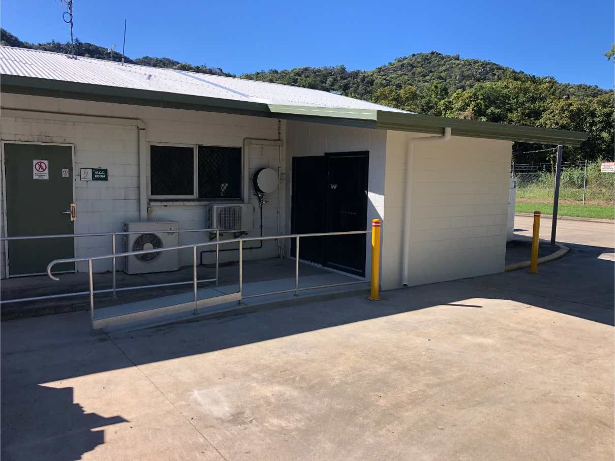 A Small White Building With a Ramp Leading to It — Shedquarters In Kirwan, QLD