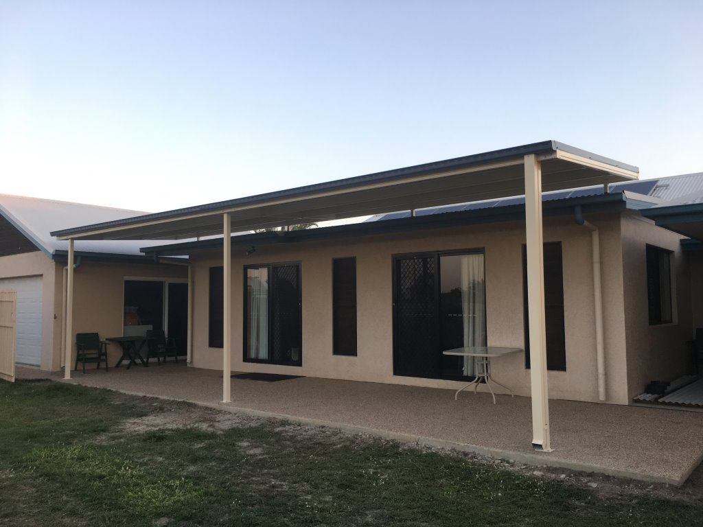 A Large Gray Building Is Sitting In The Middle Of A Grassy Field — Shedquarters In Kirwan, QLD