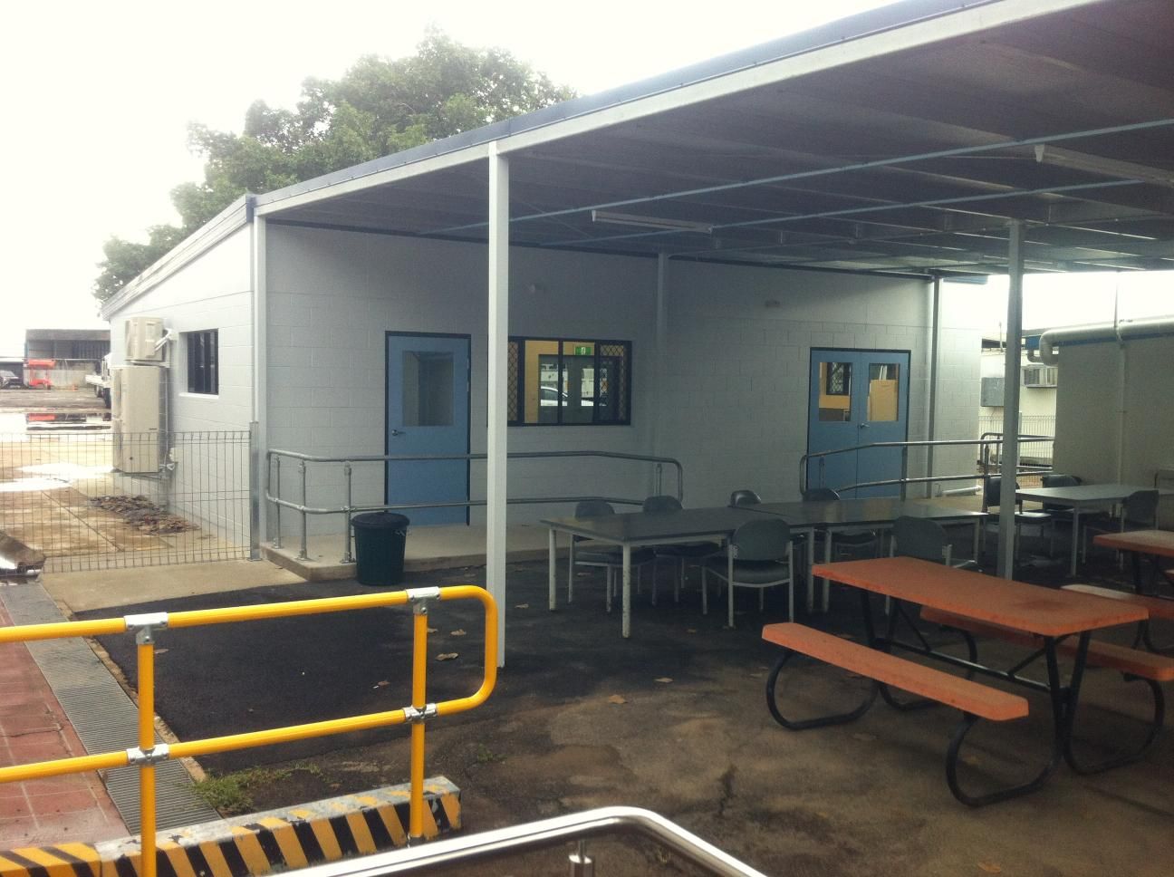 A Picnic Area With Tables and Benches Under a Canopy — Shedquarters In Kirwan, QLD