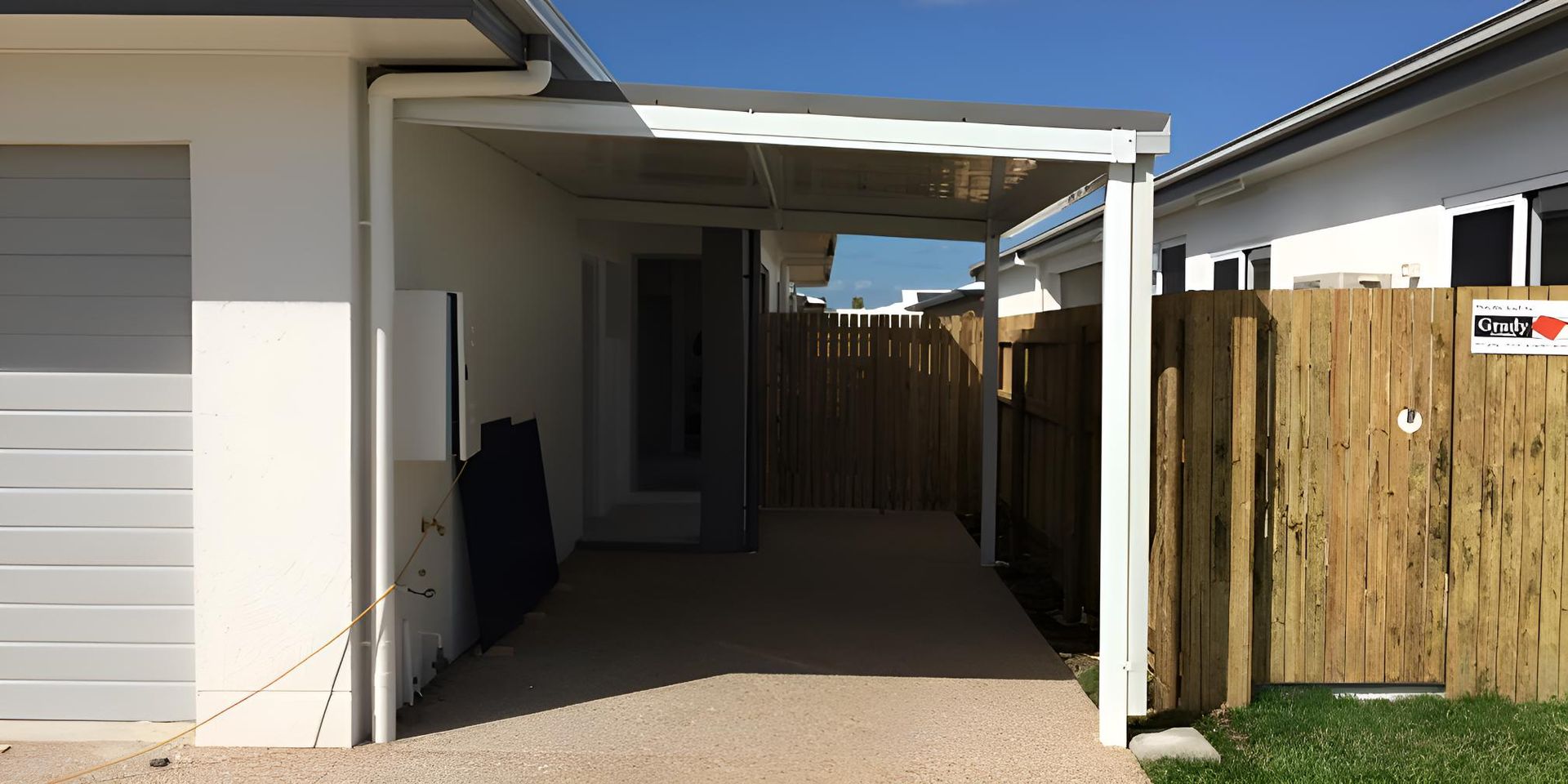 A White House With A Carport And A Wooden Fence — Shedquarters In Kirwan, QLD