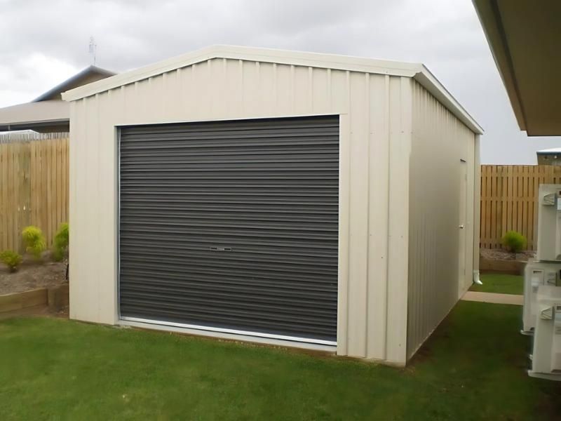 A Small White Garage With A Black Garage Door — Shedquarters In Kirwan, QLD
