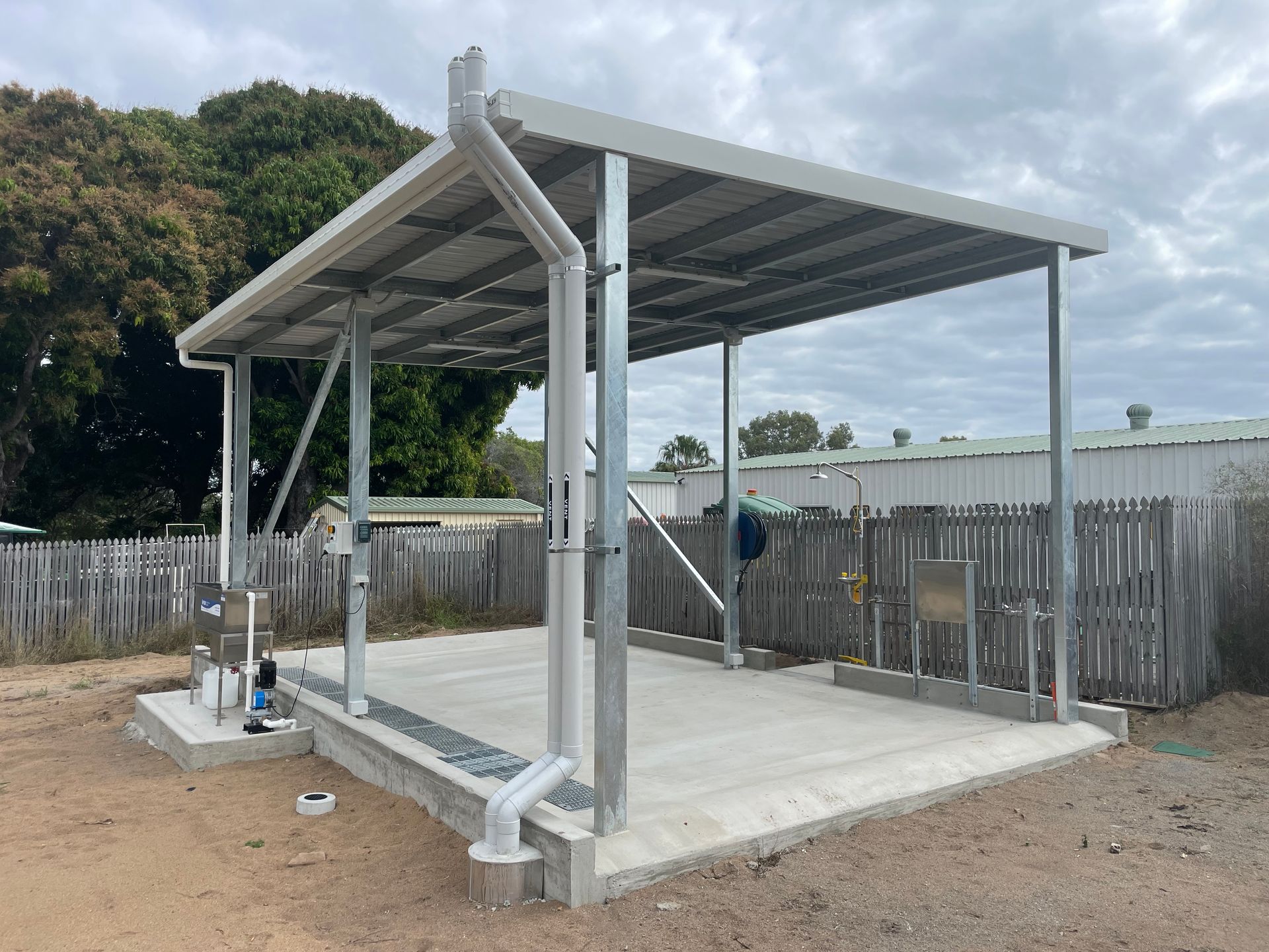A Man Drilling A Bolt Into A Metal Sheet — Shedquarters In Kirwan, QLD
