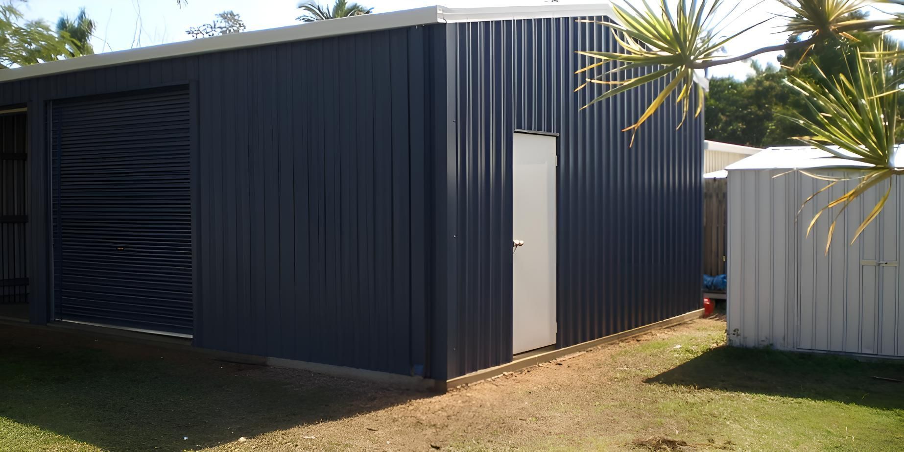 A Blue Shed With A White Door And A White Fence — Shedquarters In Kirwan, QLD