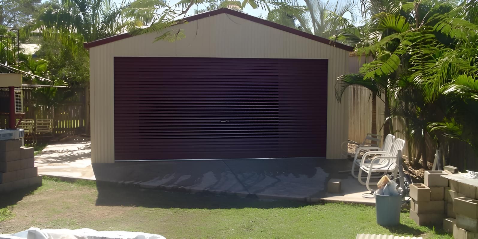 A Garage With A Purple Door Is In A Backyard — Shedquarters In Kirwan, QLD