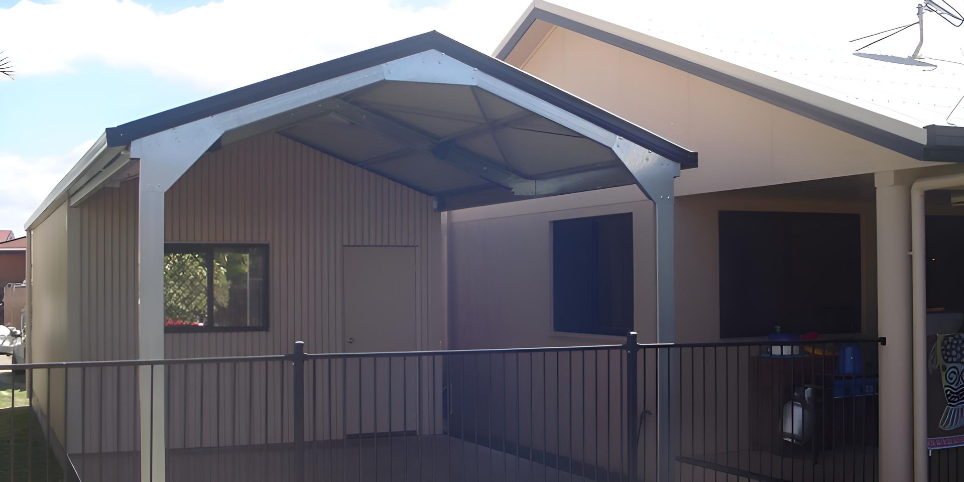 A House With A Covered Porch And A Fence In Front Of It — Shedquarters In Kirwan, QLD