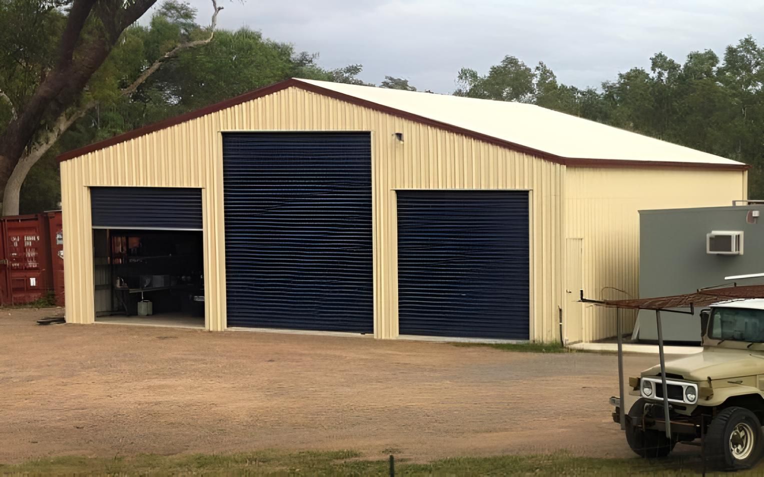 A Garage With A Jeep Parked In Front Of It — Shedquarters In Kirwan, QLD