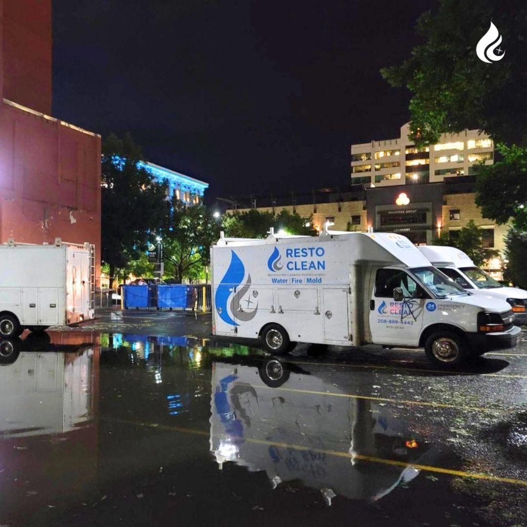 A resto clean van is parked in a parking lot at night