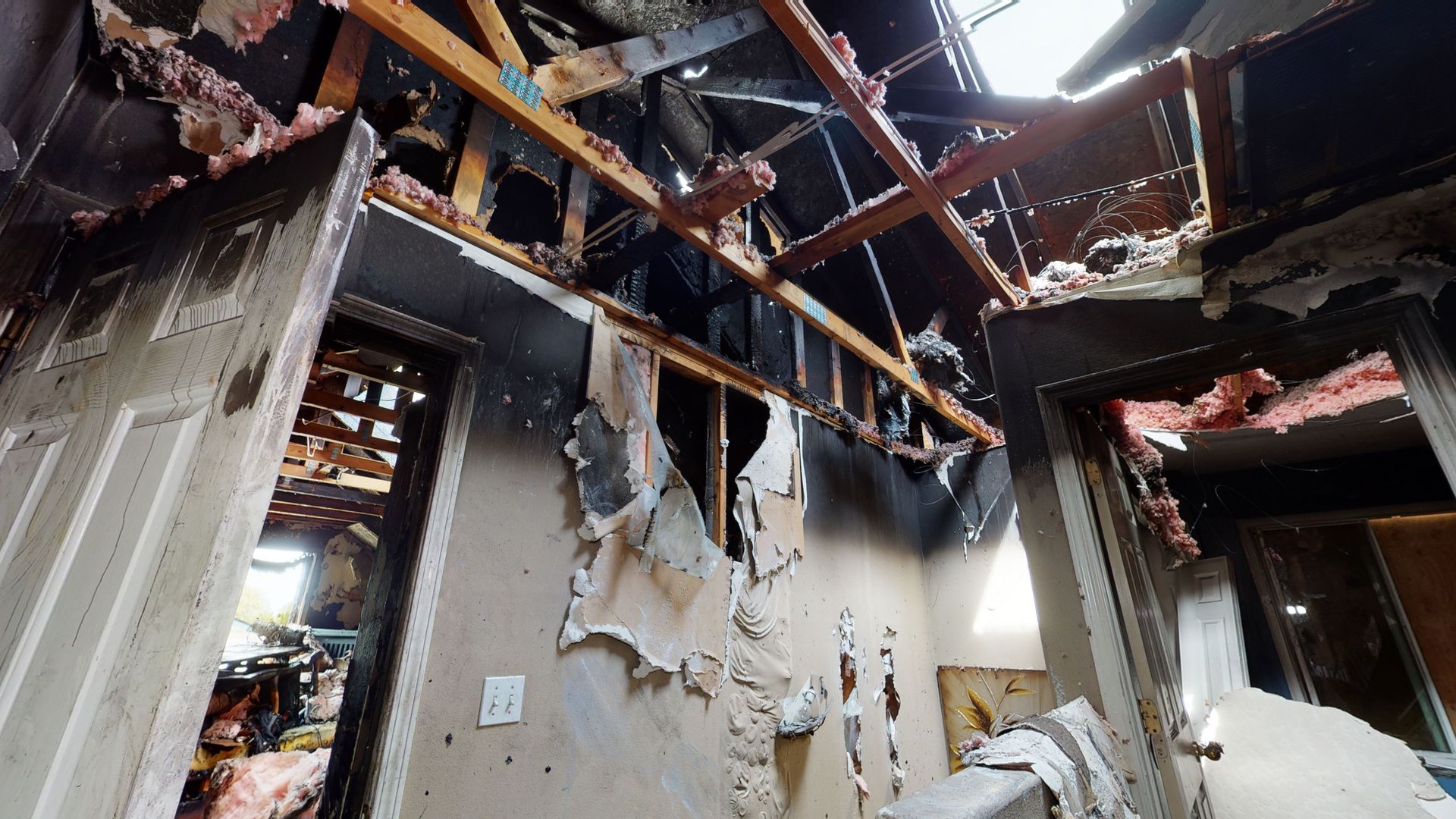 A room with a ceiling that has been damaged by a fire.