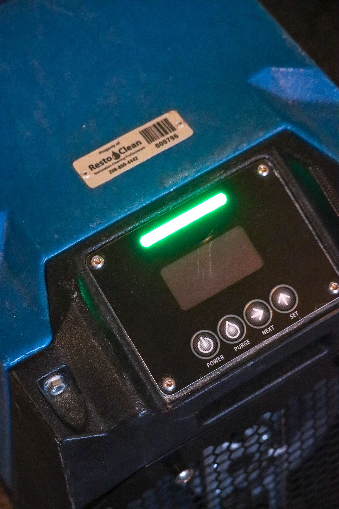 A close up of a device with a green light on it