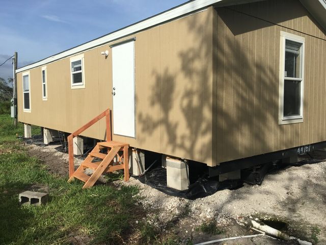 A mobile home with stairs leading up to it