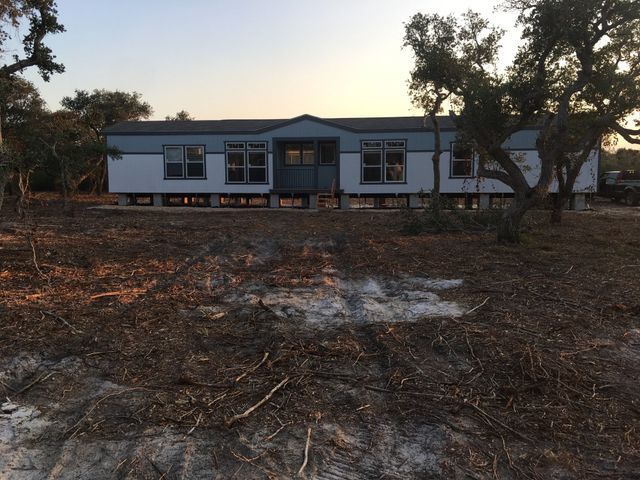 A house with a lot of trees in front of it