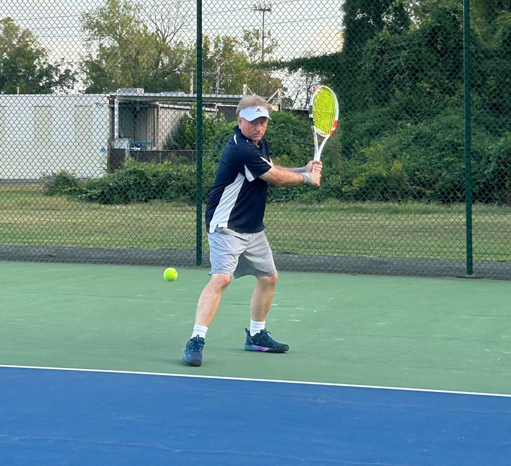 Mark Miller, PhD., Founder of Gobi Grip, on the tennis court, backhand