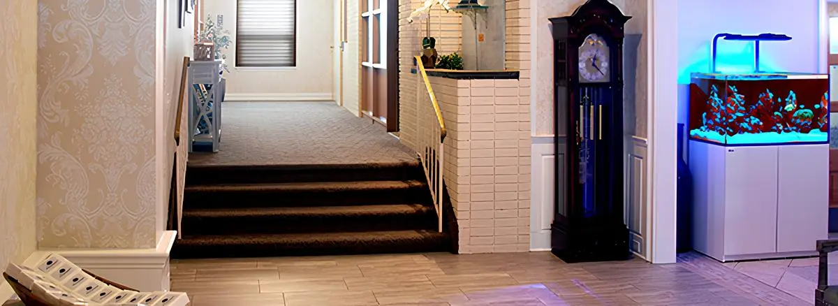 There is a large clock in the middle of the hallway.