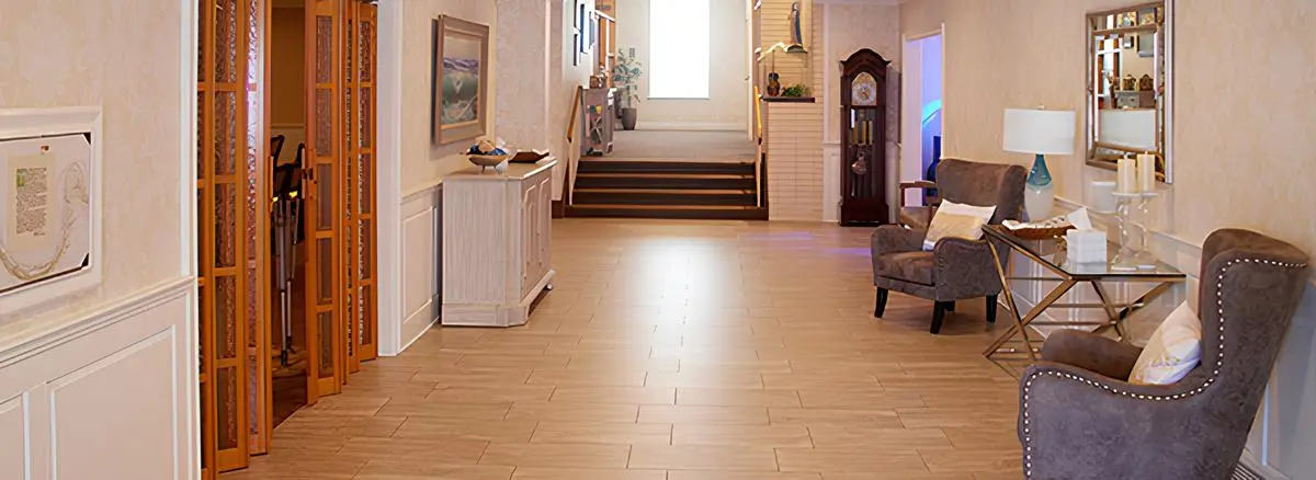 A long hallway filled with furniture and a clock.