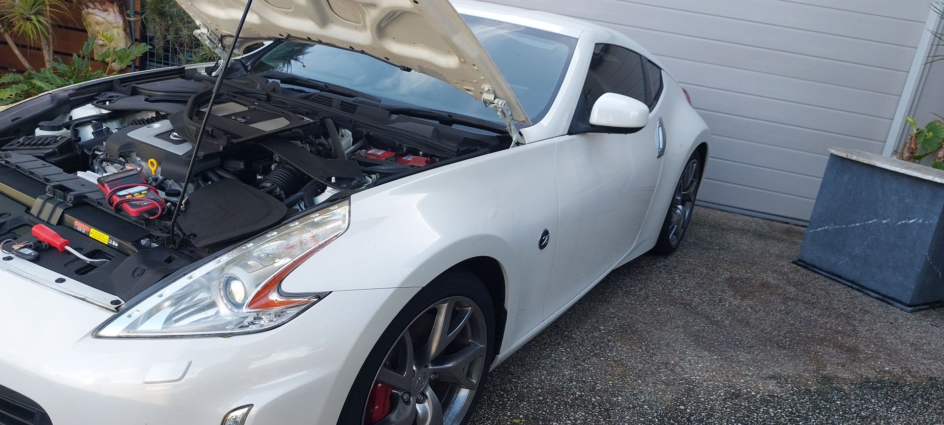 White Nissan 370z Sports Car With the Hood Open — Battery Assist Brisbane in Caloundra, QLD
