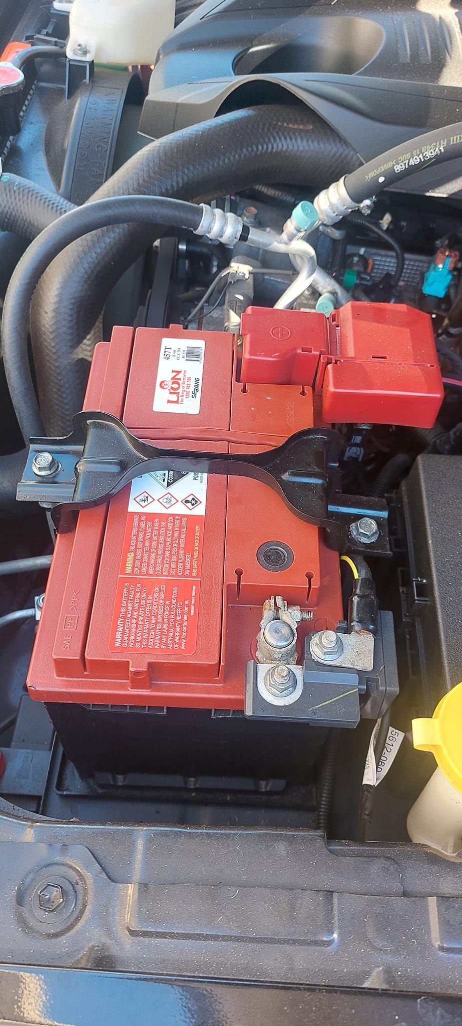 Car Engine Compartment With Red Battery and Components — Battery Assist Brisbane in Caboolture, QLD