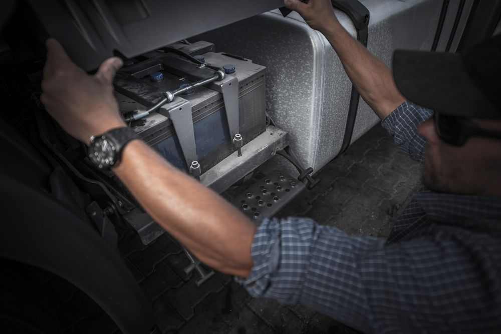 Person Working on a Truck Battery — Battery Assist Brisbane in Morayfield, QLD