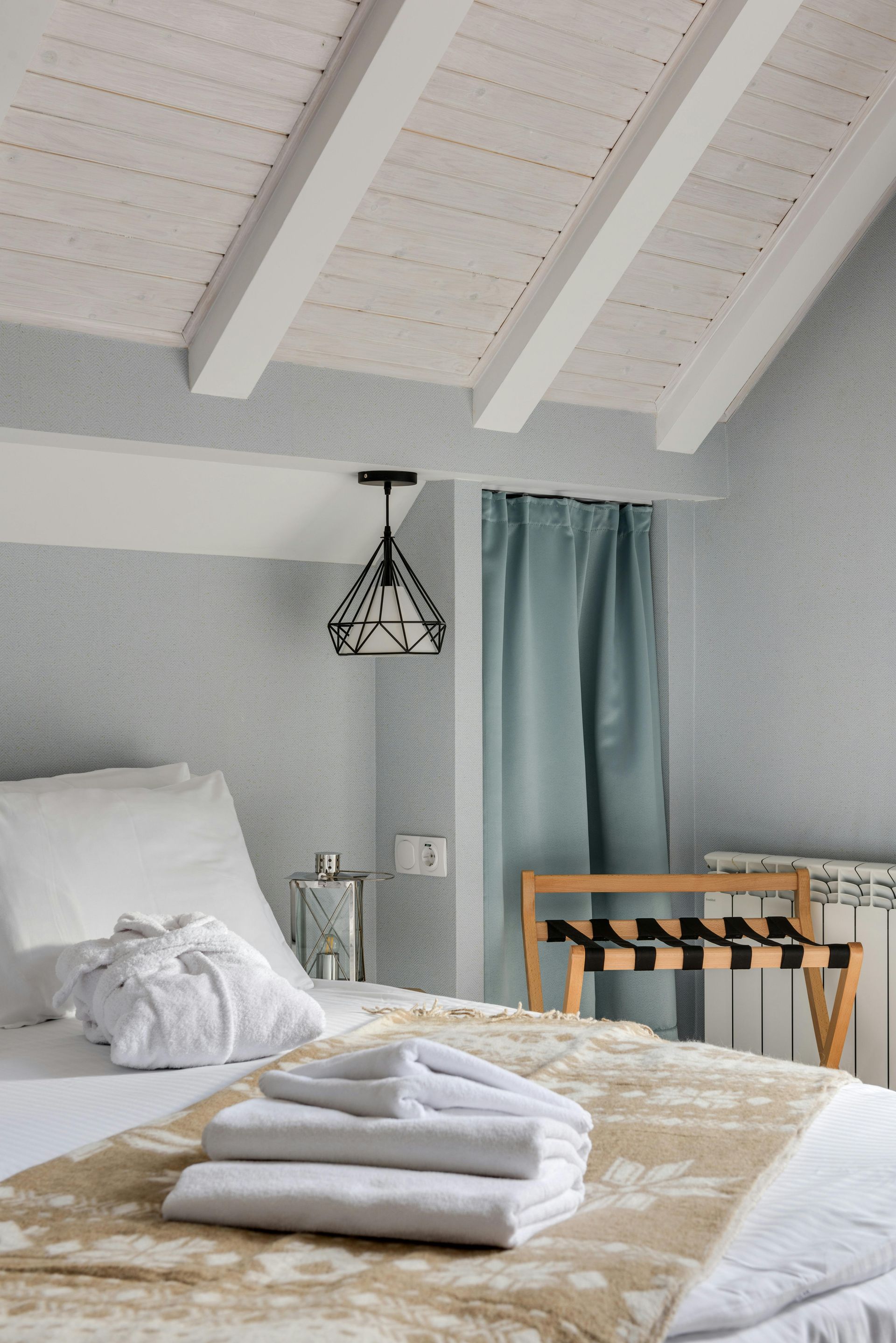 A bedroom with a bed and towels on it