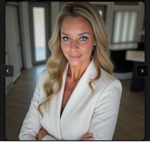 Portrait of a blonde woman in a white blazer standing indoors, arms crossed, with a slight smile Portrait of a blonde woman in a white blazer standing indoors, arms crossed, with a slight smile
