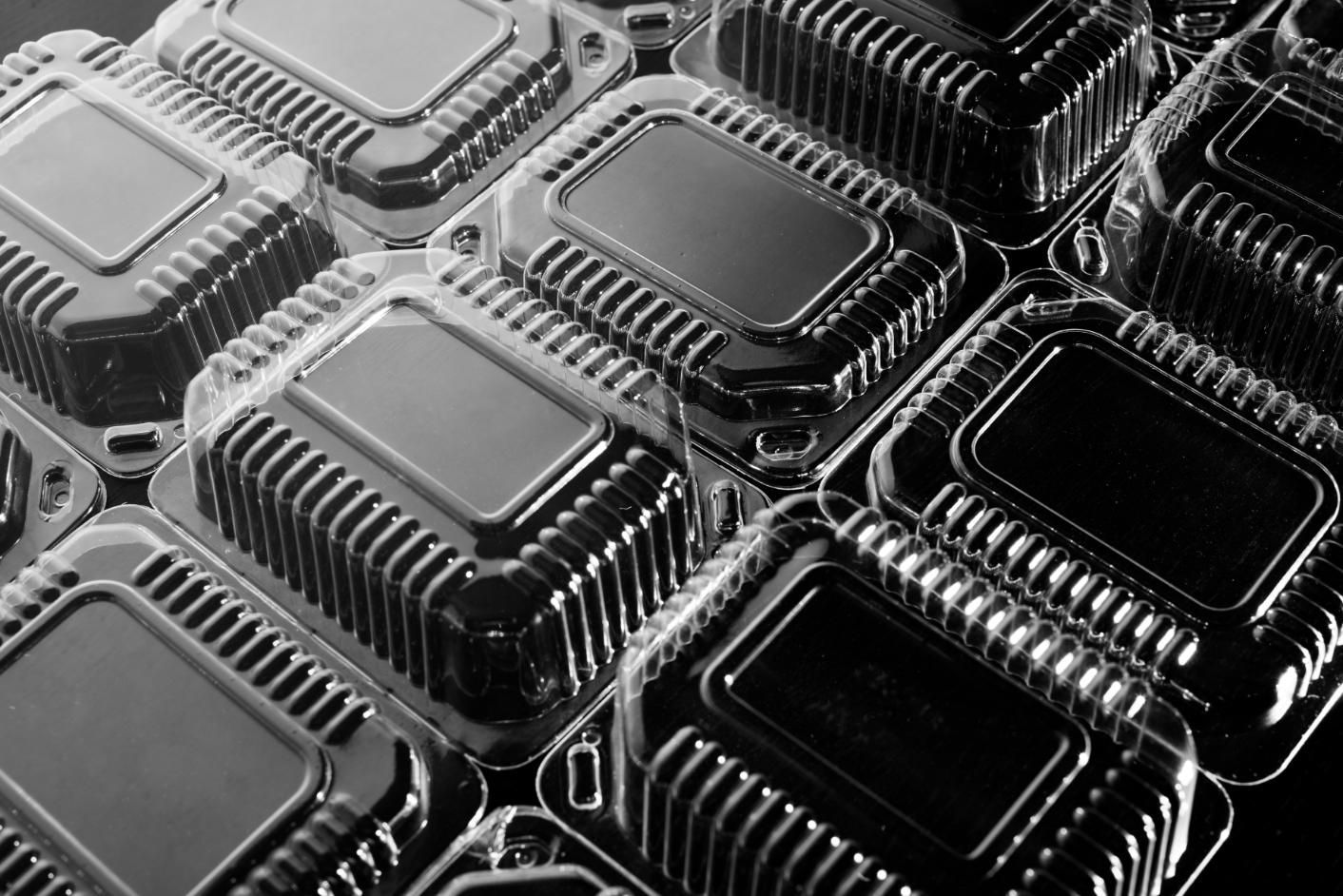 Clear plastic food containers stacked together.