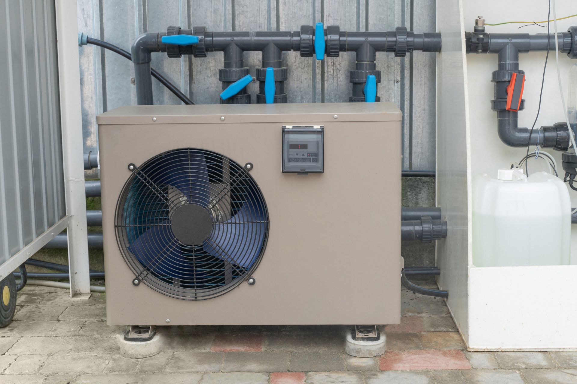 A large fan is sitting next to a tank of water.