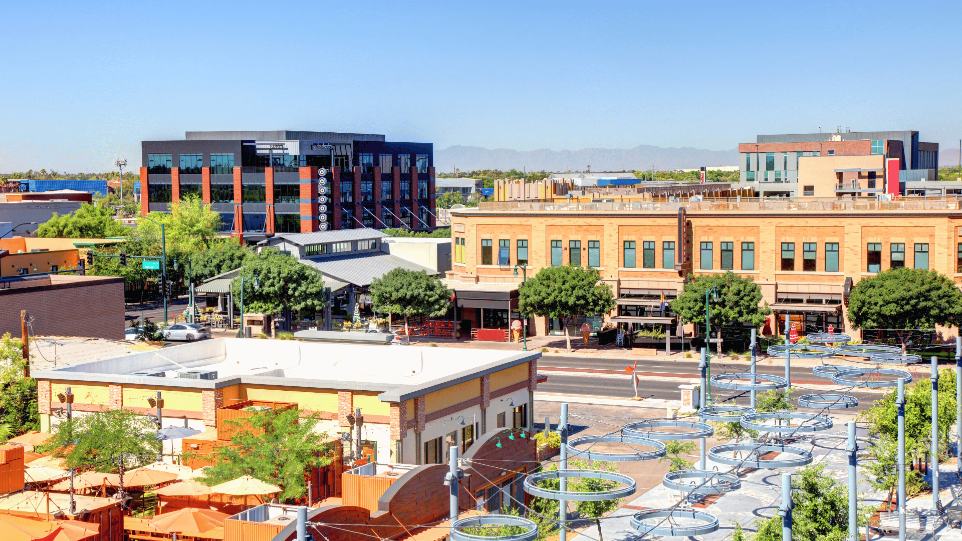 An aerial view of a city with lots of buildings and trees.