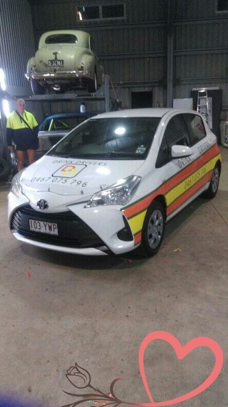 A White Car With Orange Stripes is Parked in a Garage — Drink Drivers Hervey Bay in Urangan, QLD