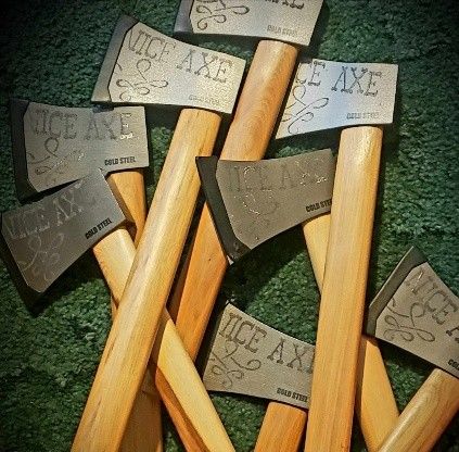 A bunch of nice axes are stacked on top of each other