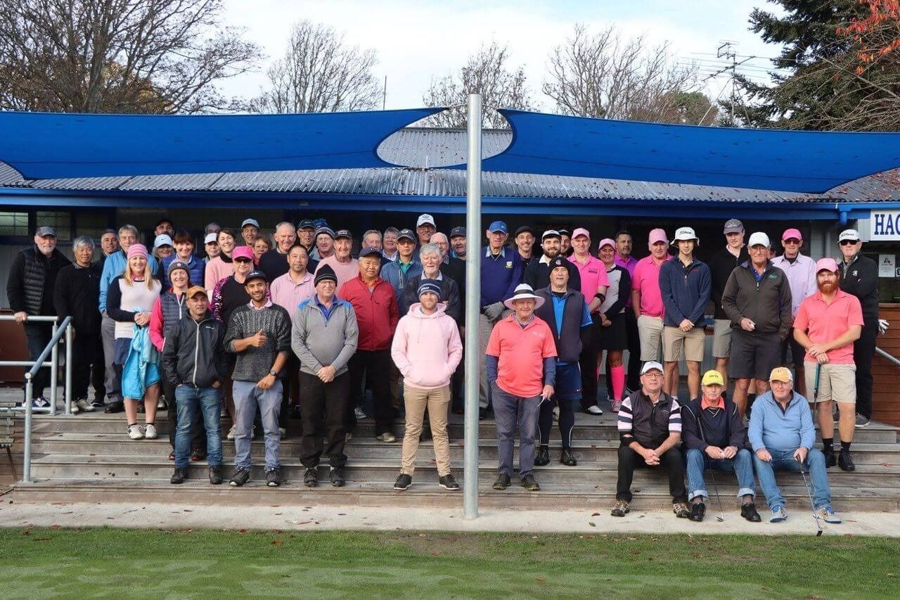 A large group of people are posing for a picture in front of a building.