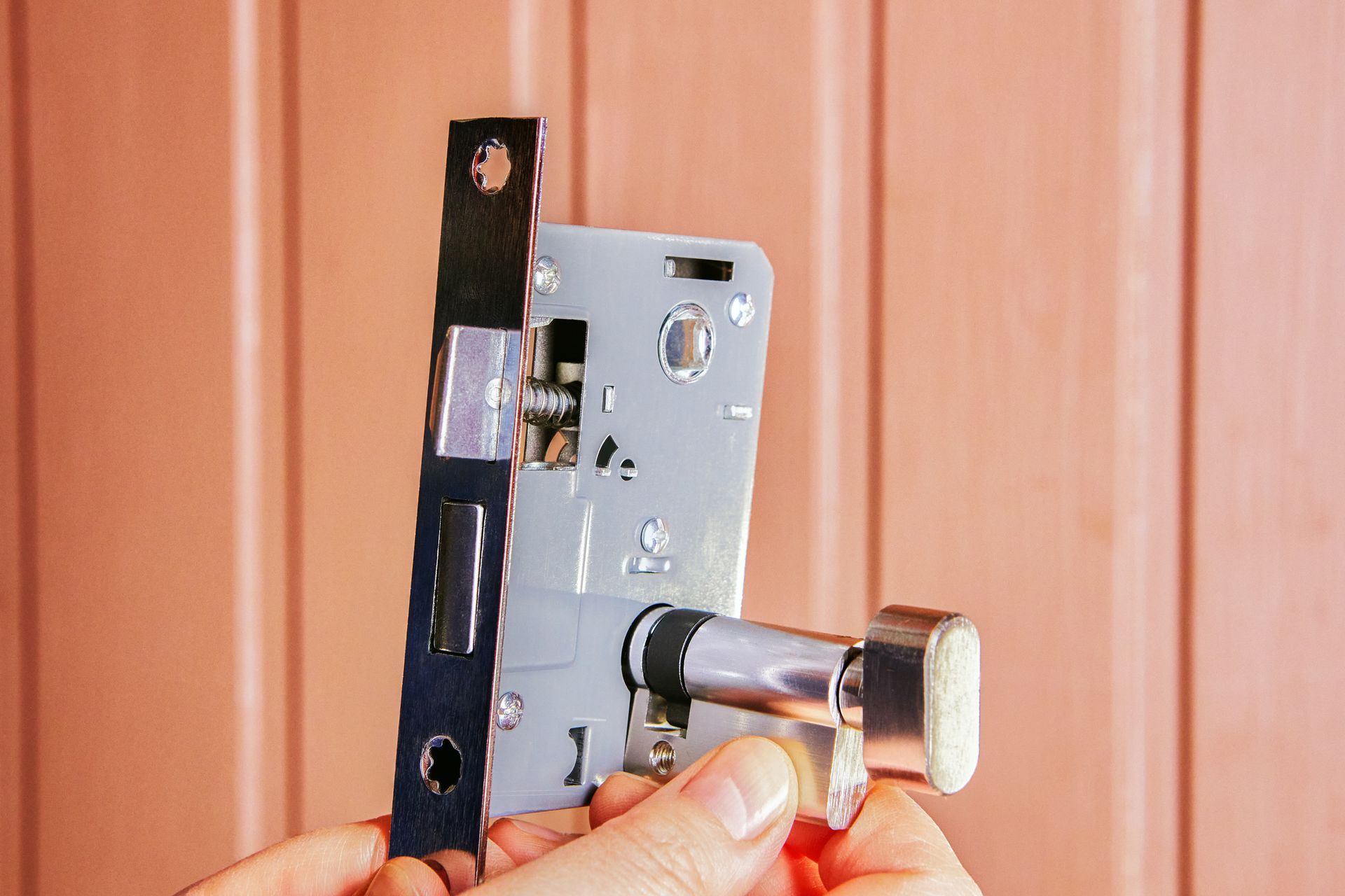 A commercial locksmith installing a mortise lock. A commercial locksmith installing a mortise lock.