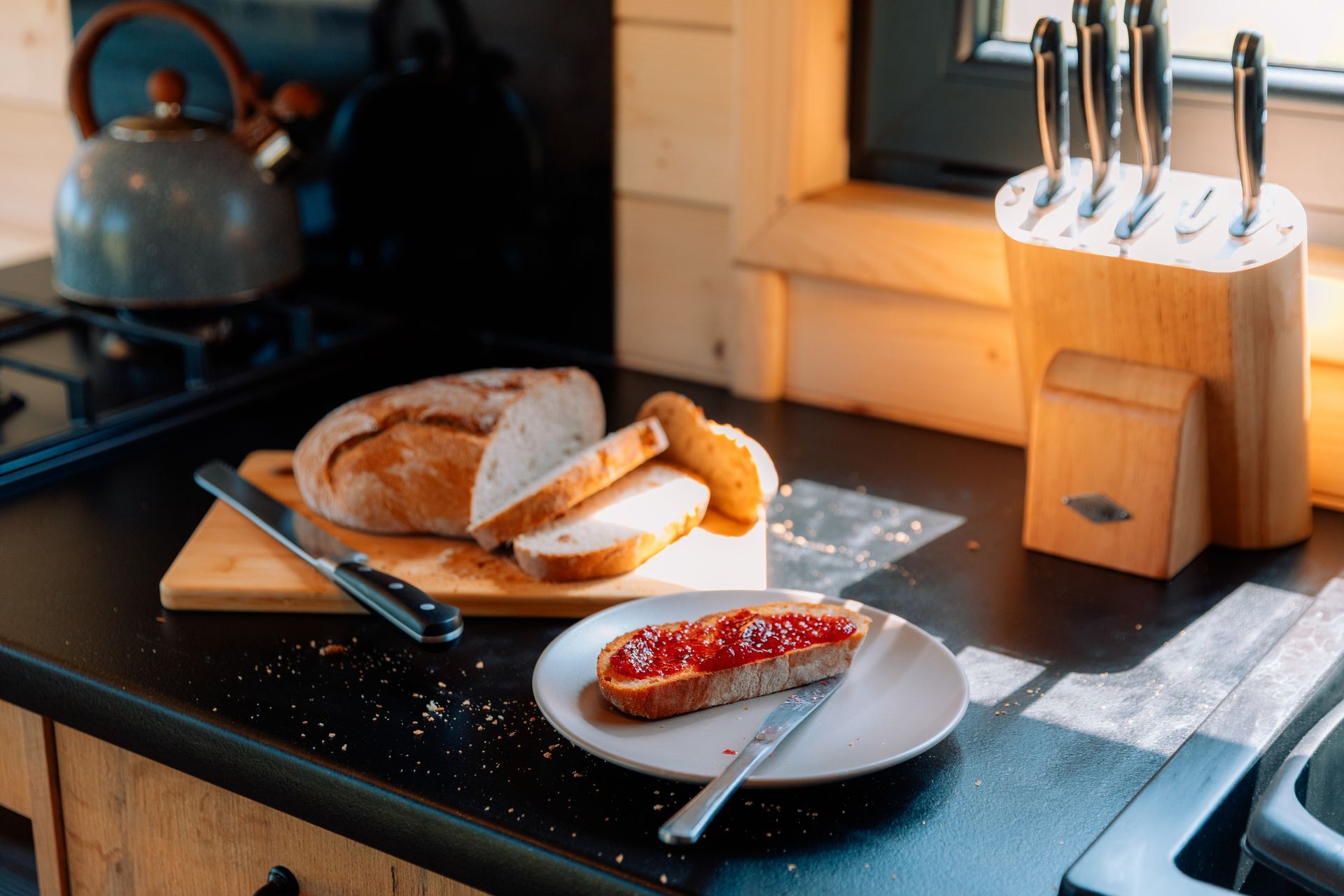 Breakfast plate with croissant and sausage inside wooden cabin.
