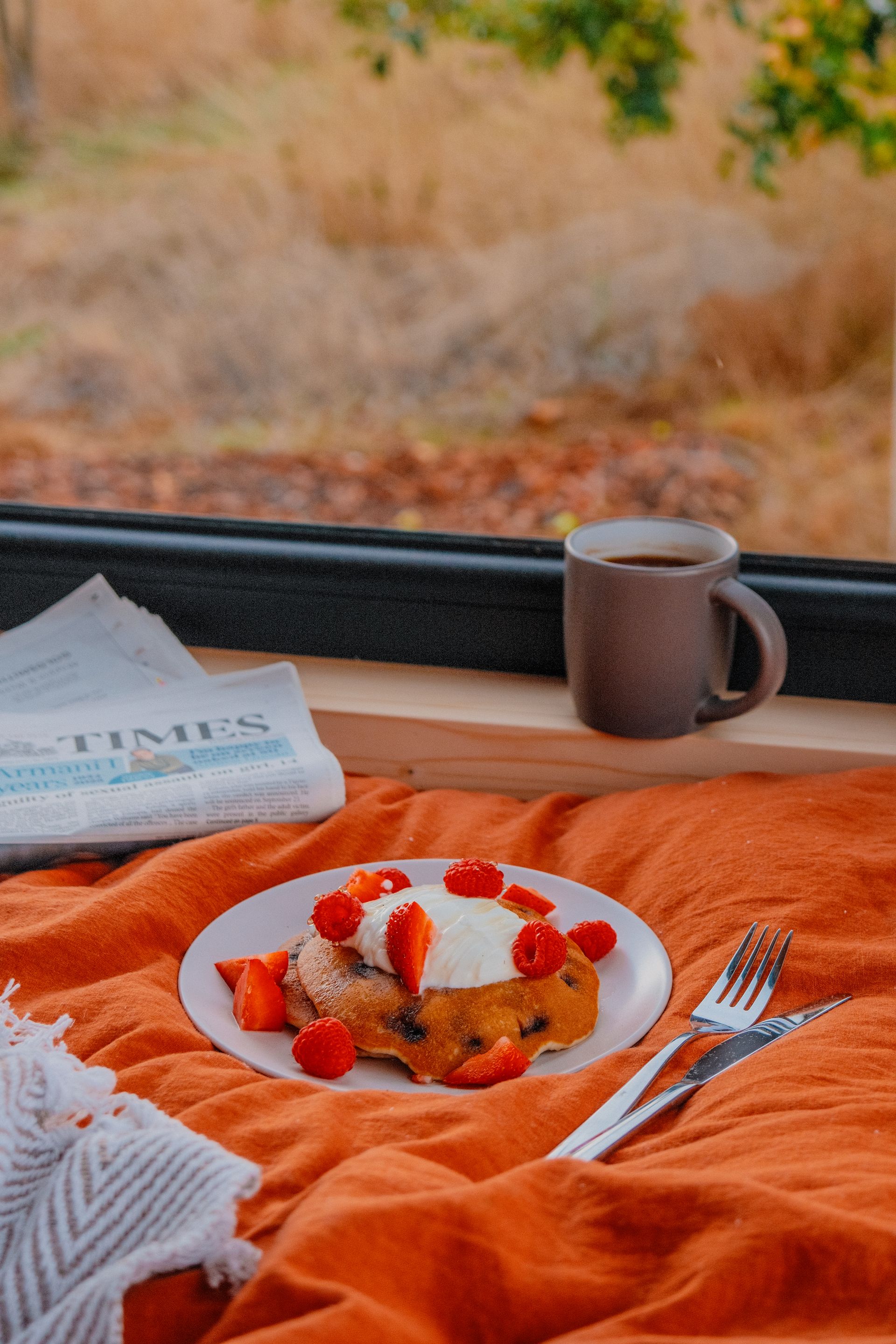 Bed with pancakes and coffee