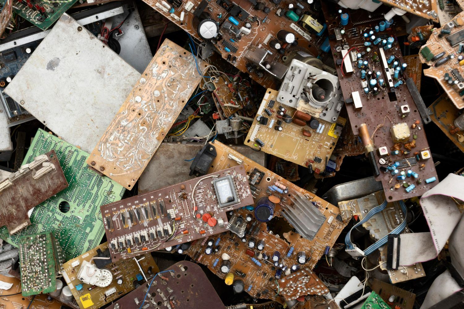 A pile of electronic waste including a bunch of circuit boards.