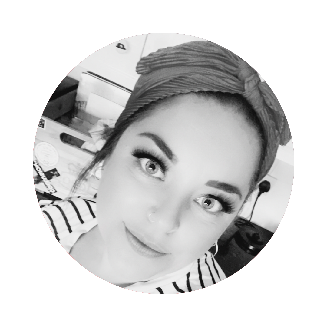 A black and white photo of a woman wearing a headband.