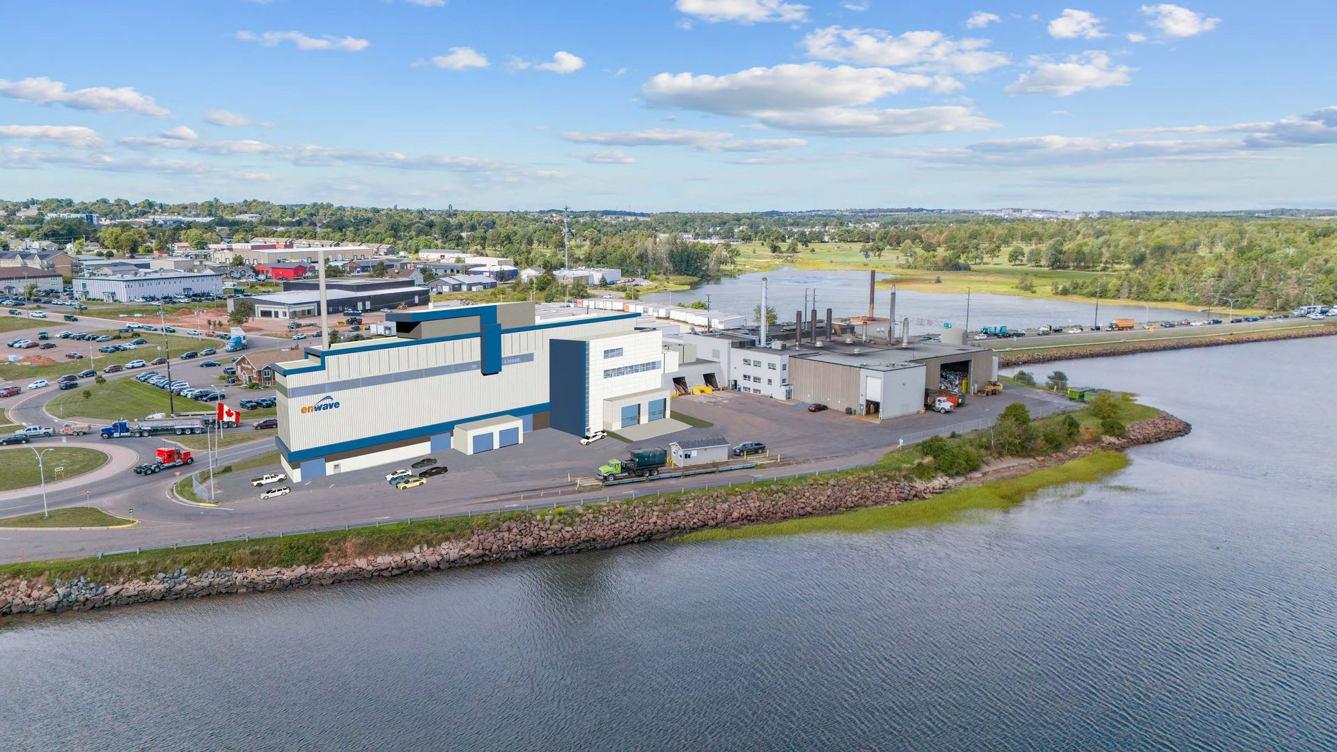 An aerial view of a large building next to a body of water.