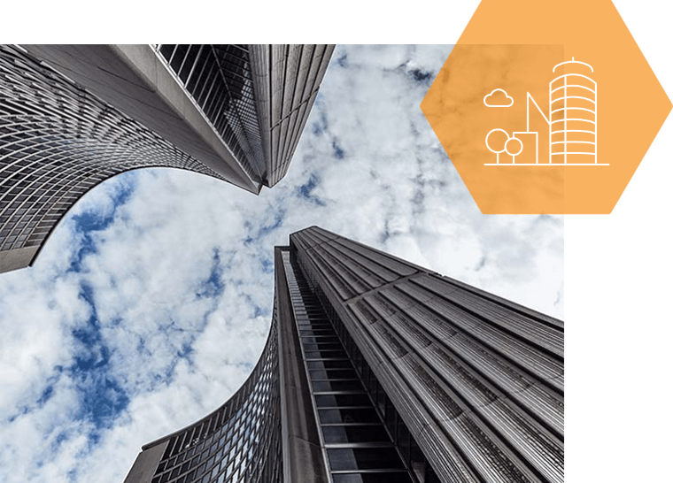 Looking up at a very tall building with a cloudy sky in the background.