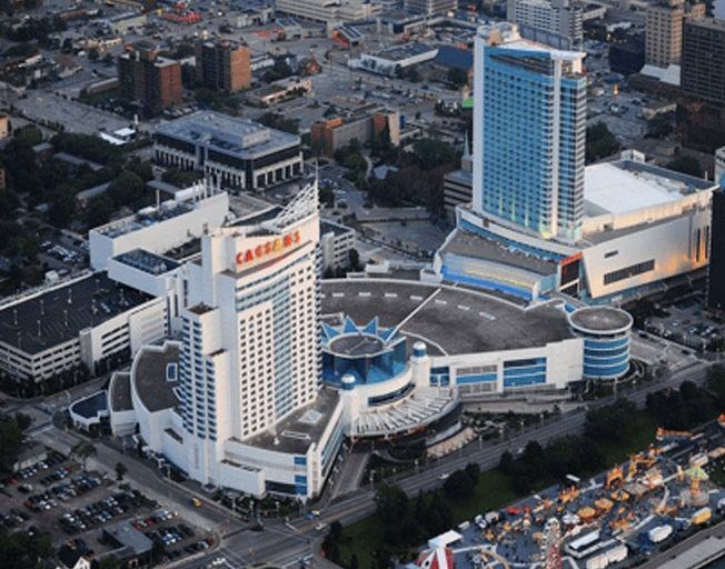 A large building with a lot of windows and a car parked in front of it.
