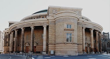 A large building with columns and a dome on top of it.